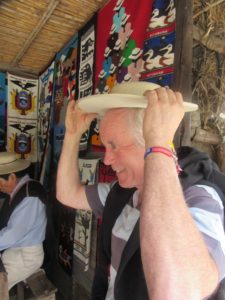 Man trying out a hat in Ecuador